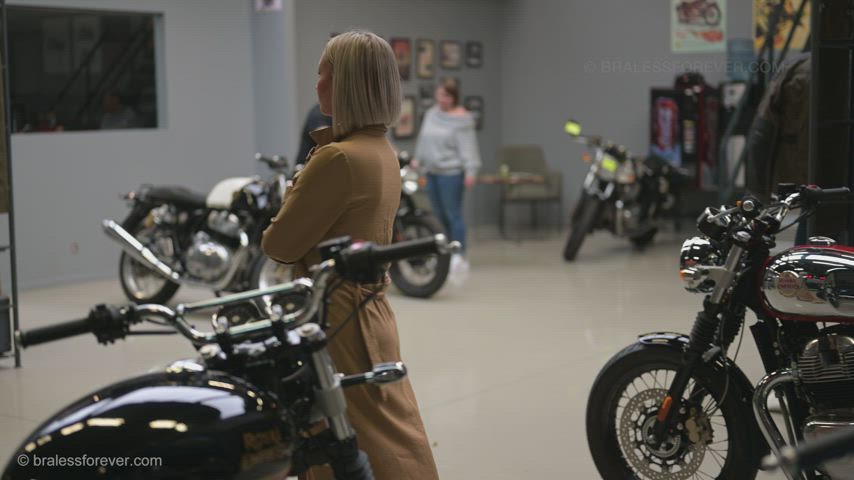 Anne flashing in the motorcycle shop