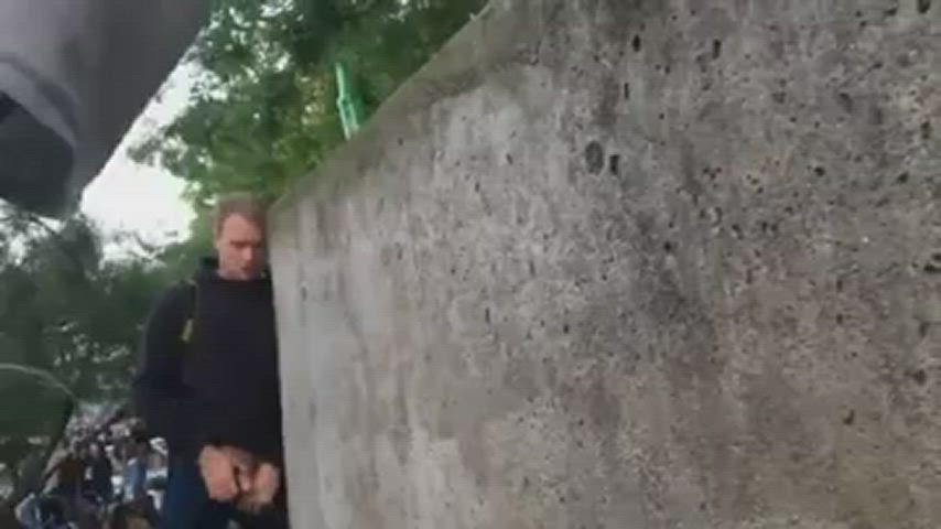Pissing on a wall at a festival