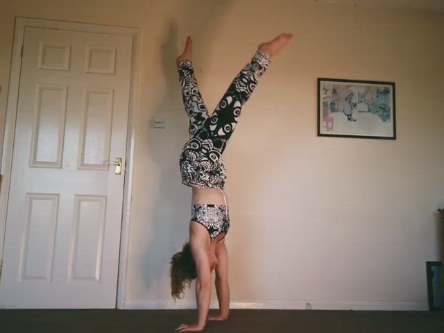 Hoopsy Daisy taking her pants off in a handstand