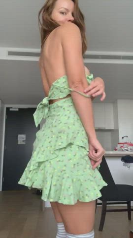 Taking off green dress