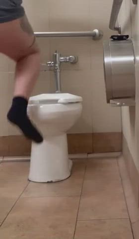 She's not even trying to get it in the toilet