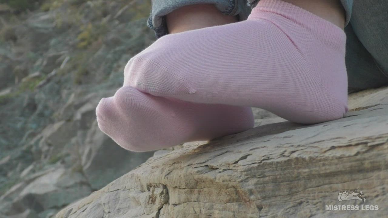 My jeans feet in cute pink ankle socks on the seashore