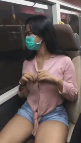 Flashing her tits on a train