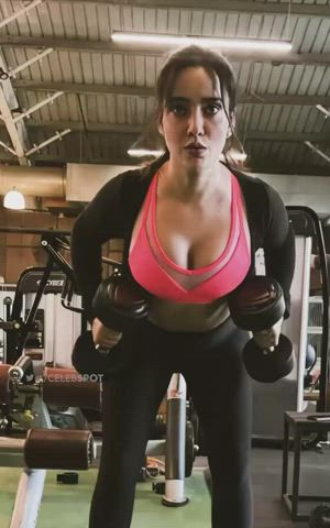 Neha Sharma struggling to keep her voluptuous assets in a small gym bra.