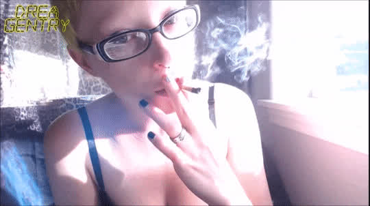 blue eyes cleavage glasses goth lips short hair smile smoking gif