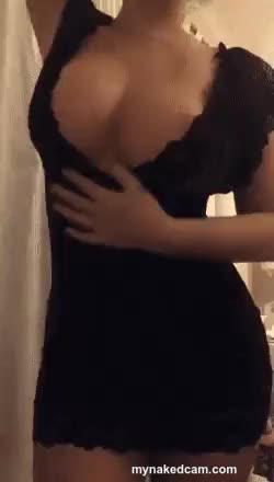 Hot curvy girl in black tight dress showing her boobs