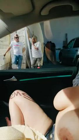 Flashing her big tits from the car to strangers