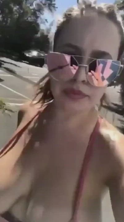 Walking around with her huge tits stuffed into a bikini