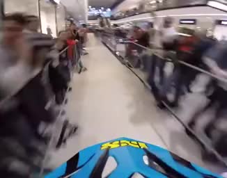 Mountain bike racing through a mall