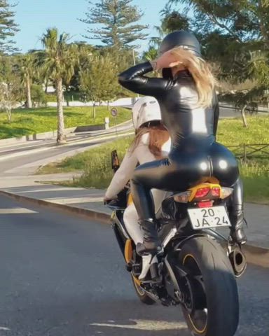 Her shiny ass really enhances the visibility of their bike