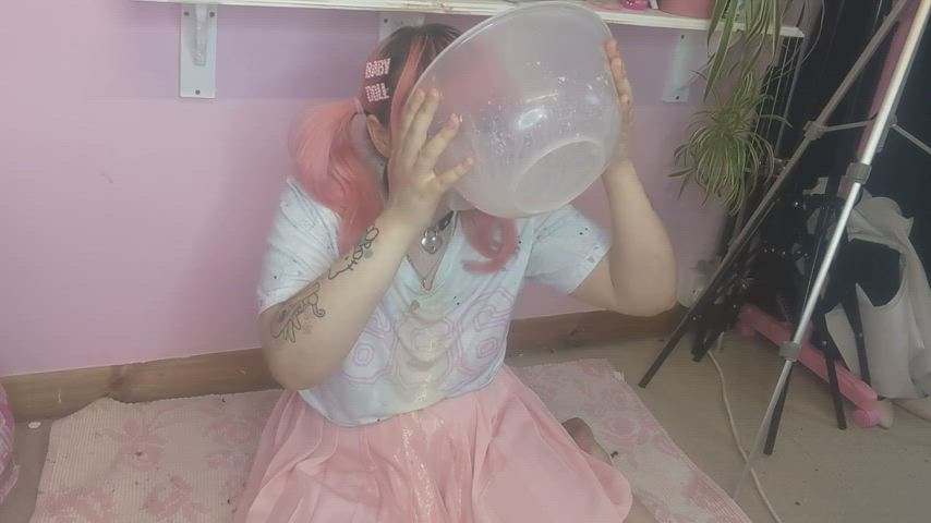 Pink haired girl pukes in her bowl