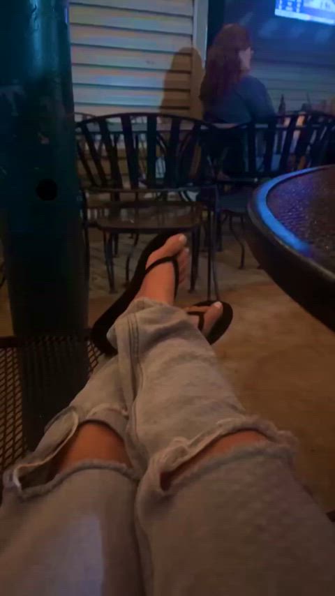 Showing off my flip flops at the bar 