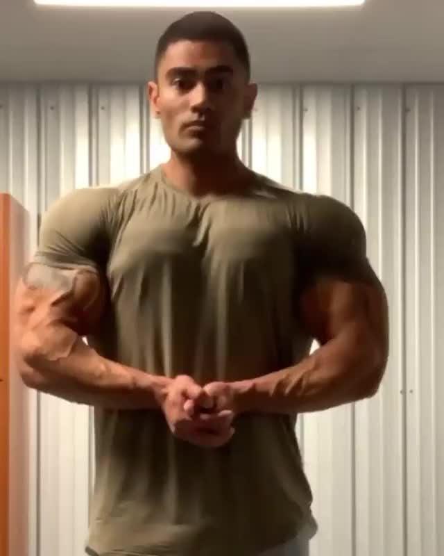 Flexing his muscles in a shirt