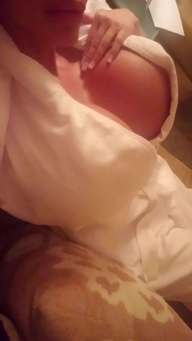 Gently caressing her monster tits in robe