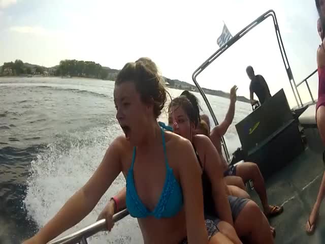 The waves pull her top off