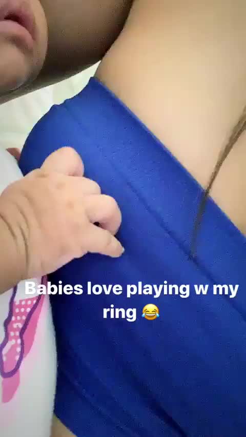 Baby playing with Renee's nipple