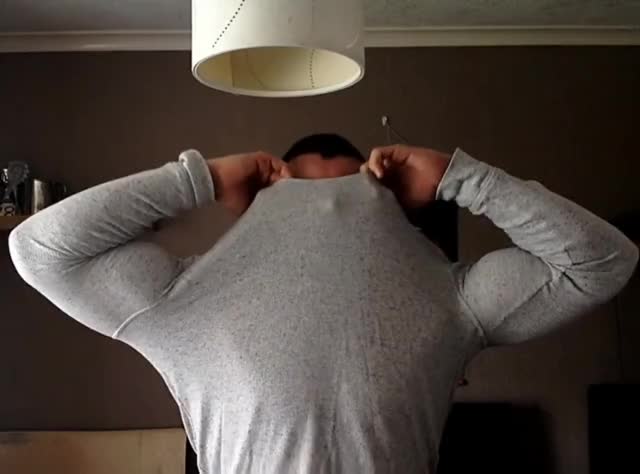 Big guy taking off a tight shirt