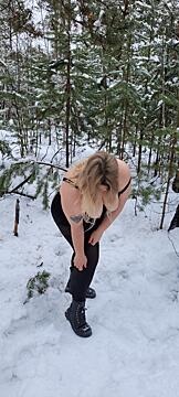 Hot blonde with big breasts and snow-covered forest