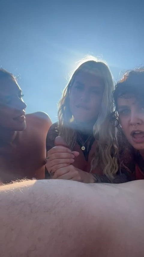 Guy getting his dicked sucked by 3 girls on the beach.