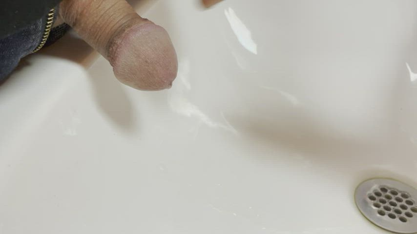 Close up pissing in the sink