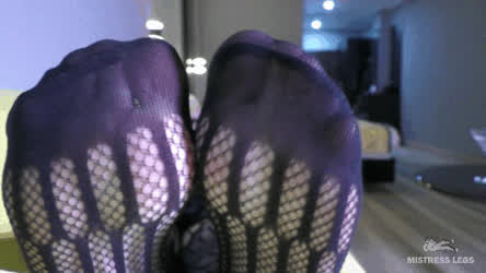 Toes wiggling in black mesh bodysuit