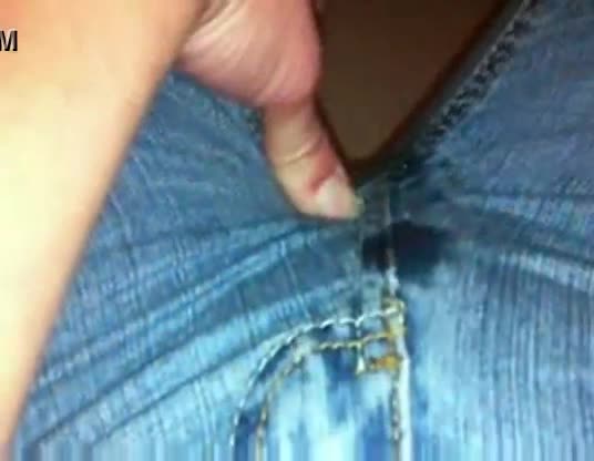 Rubbing and wetting her jeans