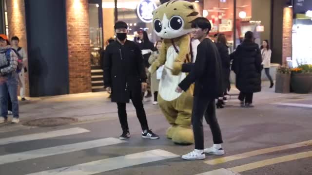 Korean mascot with korean girl busker