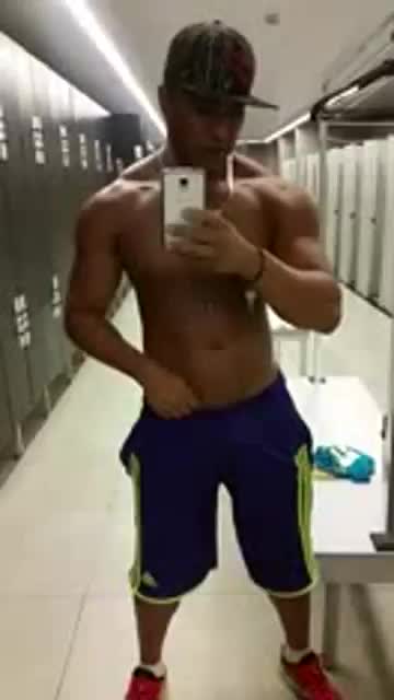 Jerking his cock in the locker room mirror