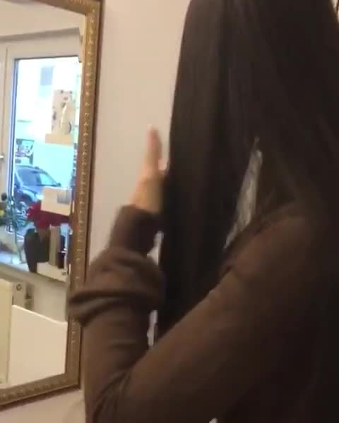Brushing long brunette hair