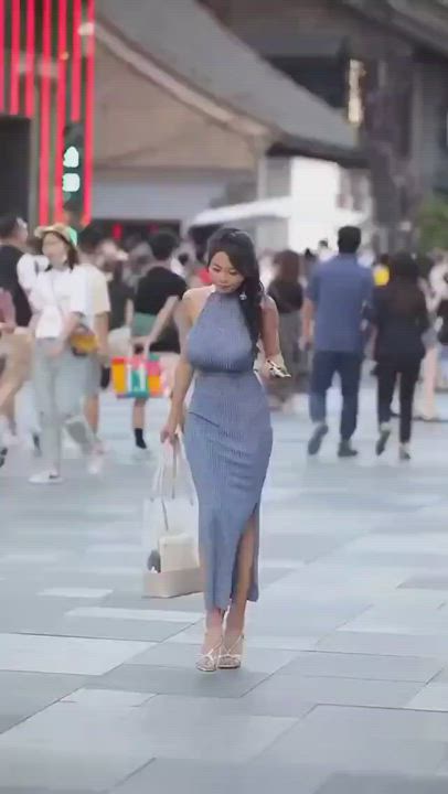 Busty beauty walking in the street