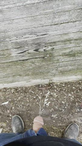 Pissing on the side of an abandoned barn