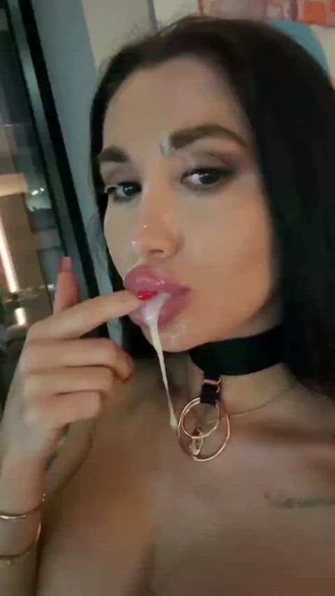 Playing with the cum in her mouth