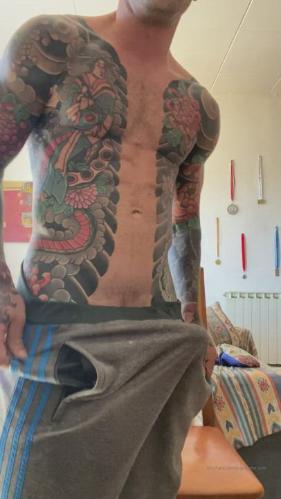 Tattooed guy jerking off