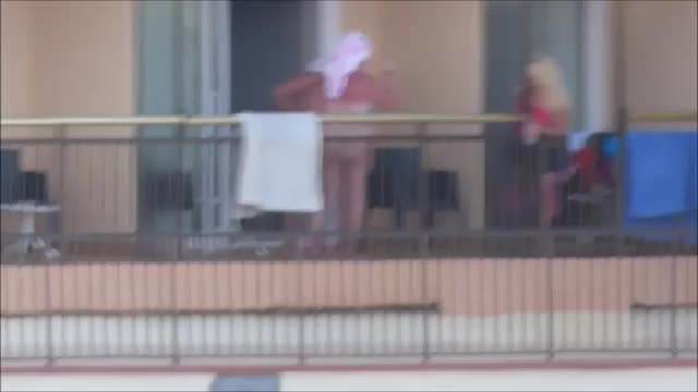 spy front of hotel balcony