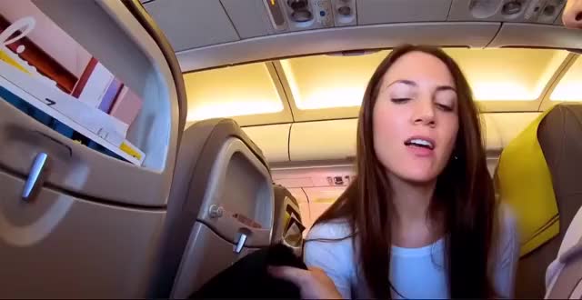 Naughty girl swallows on a crowded plane