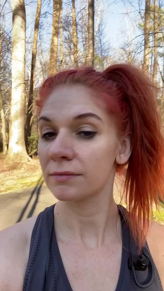 Sweaty redhead runner girl shows off tits on the trail