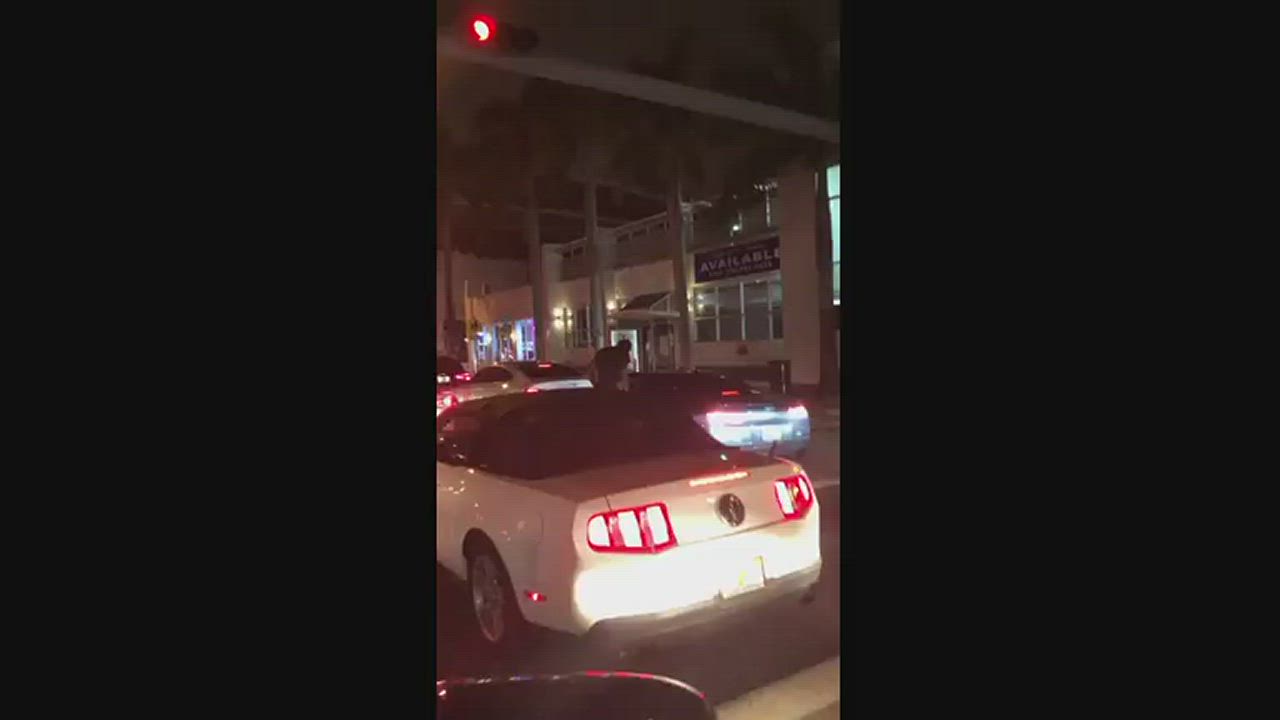 White girl pleasing a random black bull in the street.