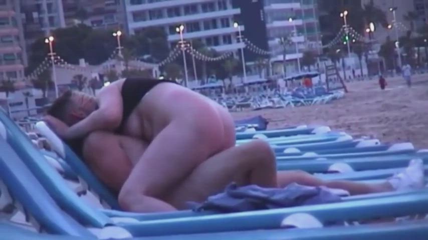 Quality time of amateur French couple on public beach before sunset