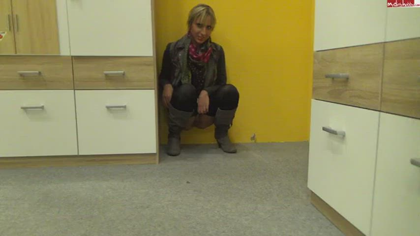 Cute blonde pees on floor in Ikea