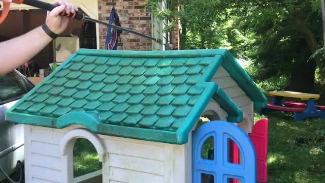 power-washing a toy house