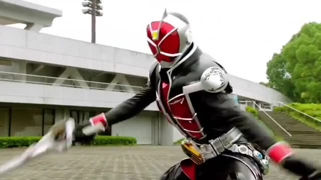 Kamen Rider Wizard slices Minotaurus, destroys axe, sends him flying