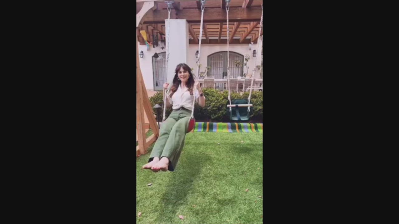 Zooey Deschanel shows her soles on the swing set