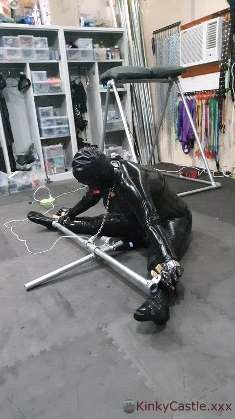 Rubberdoll "Toy 50" immobilised in a condom suit and resting her clit on