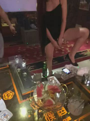 Chinese Waitress serving a bottle of beer